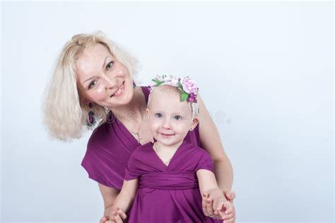 Blonde Mom And Daughter In Studio On White Background Stock Image