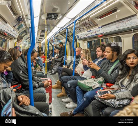 London Underground Tube Train Passengers Commuters Sitting Inside A Busy Piccadilly Line