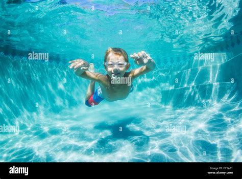 Underwater Young Boy Fun In The Swimming Pool With Goggles Summer
