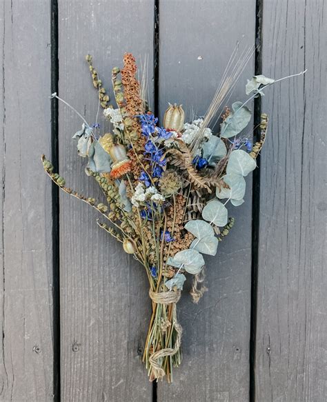 It produces dense clusters of pale blue flowers during the spring, and the foliage in the fall turns a golden color. Rust & Blue Dried Flower Bouquet - Idyllwild