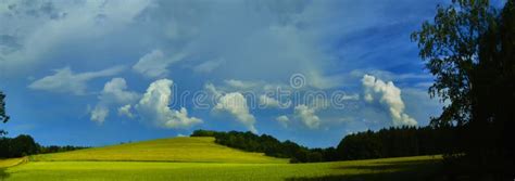 Scenic Landscape With Storm Cloud In Background Over Green Agriculture