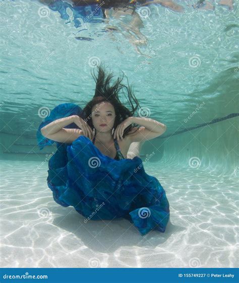 A Dark Haired Women Model In Various Outfits Underwater Stock Image Image Of Model Person