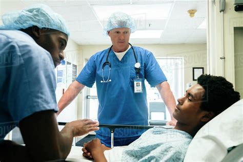Nurses Talking To Boy In Hospital Bed Stock Photo Dissolve