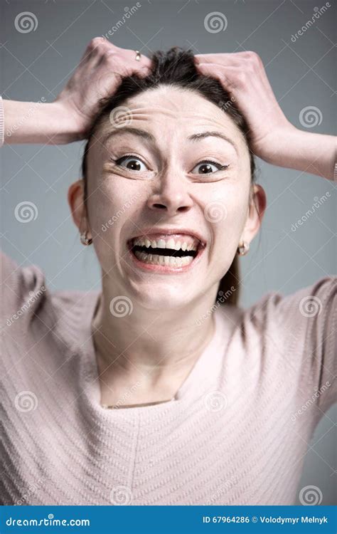Portrait Of Young Woman With Shocked Facial Expression Stock Photo