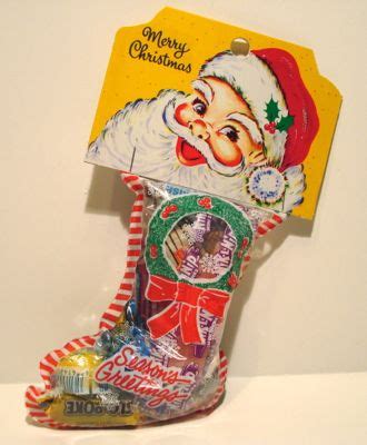 Christmas presents, tinsel and decorations on a rustic background. Christmas Stocking Filled With Candy