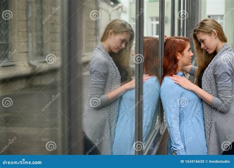 Portrait Of Two Lesbians Standing On The Street And Gently Touching