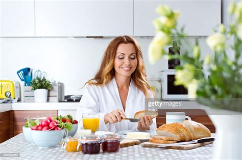 Beauiful Woman Eating Breakfast At Home High Res Stock Photo Getty Images