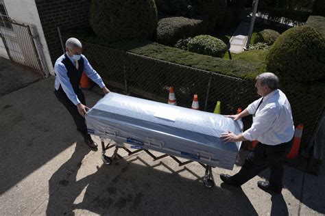 Closed Caskets Empty Chairs At Funeral Home In Virus Center Ap News