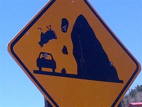 A Street Sign Warning Drivers That There Is A Bulldozer On The Road