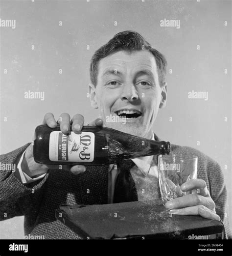 advertisement for mandb all bright beer male model bob bell pouring beer from a bottle into a