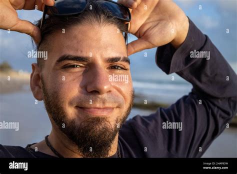 Young Man Of Hipster Or Hippie Appearance With Happy Face On The Beach