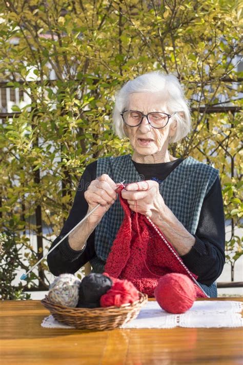 90 Years Old Woman Knitting A Red Sweater Stock Photo Image Of