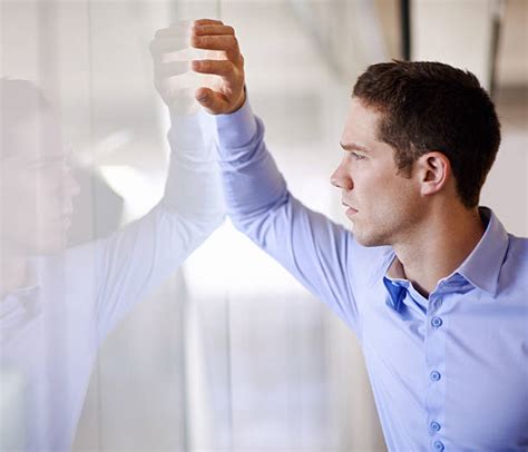 Side View Of A Young Business Man Leaning On Wall Stock Photos