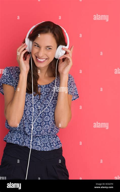 Happy Young Woman Listening And Enjoying Music With Headphones Isolated
