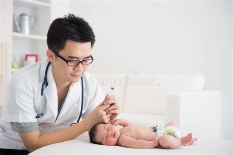 Good Looking Asian Doctor And Newborn Baby Stock Photo Image Of Exam