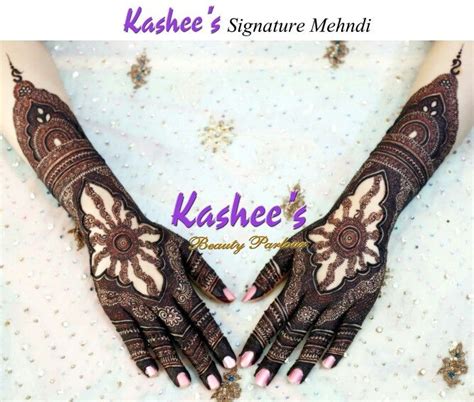 Here is the captivating delicate bands of flowers with minimalistic henna patterns around the motif give a stunning vibe on the bride's hands. Kashee's signature mehndi | Henna designs hand