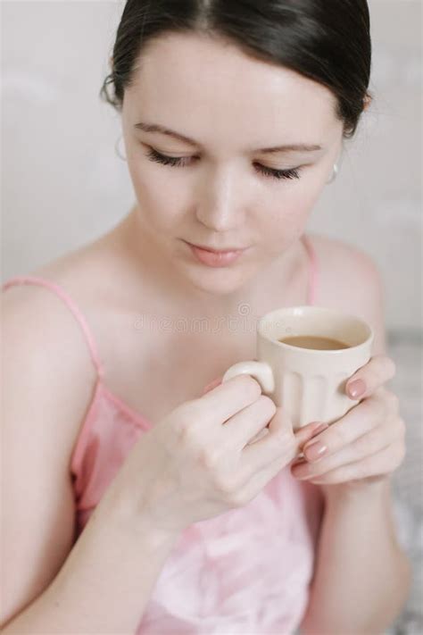 Cup Of Coffee In Hands Of Young Woman In The Morning Portrait Of A