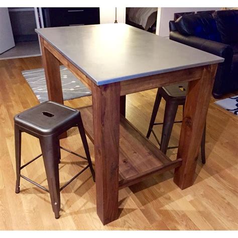 The table's surface is resistant to liquids. West Elm Rustic Kitchen Island/ Bar Table w/ 2 Crate ...
