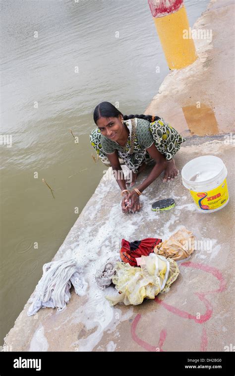 Indian Woman Washing Clothes By Hand Next To A River Andhra Pradesh