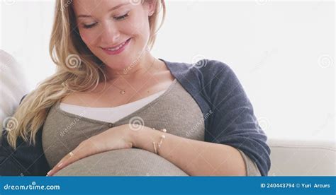 Bonding With My Bump 4k Footage Of A Woman Rubbing Her Pregnant Belly While Relaxing On Her