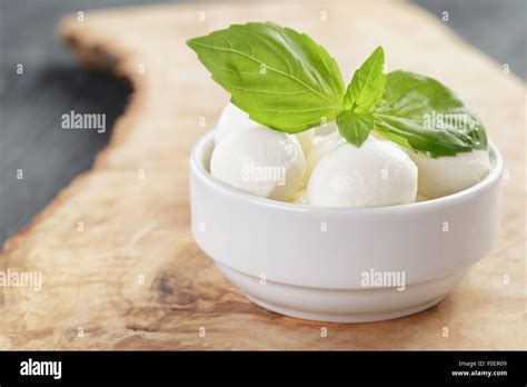 Small Balls Of Mozzarella In Bowl With Basil Stock Photo Alamy