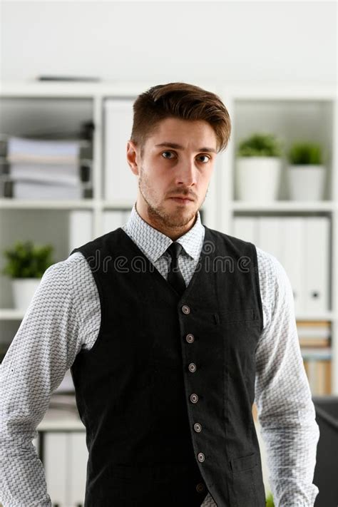 Handsome Smiling Man In Suit And Tie Stand In Office Stock Photo