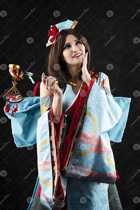 beautiful leggy busty cosplayer girl wearing a stylized japanese kimono costume cheerfully