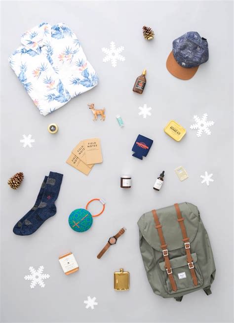 The Contents Of A Backpack Laid Out On Top Of Snowflakes