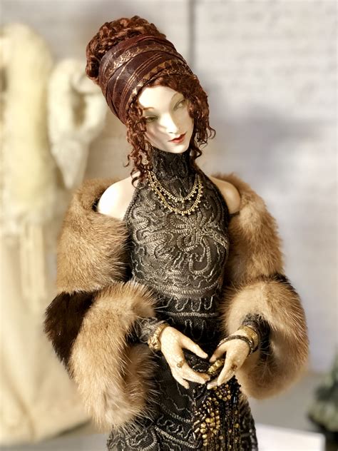 A Mannequin Dressed In Black And Gold With Furs On Her Head Holding A