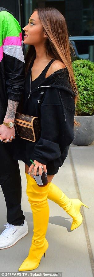 Ariana Grande Stuns In Canary Yellow Thigh High Boots While Stepping