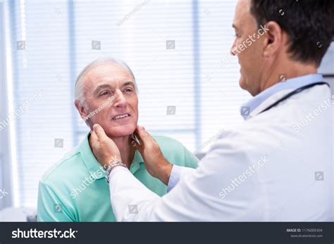 Doctor Examining Senior Patients Neck Clinic Stock Photo 1176009304