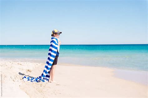 Babe With Striped Towel Cape At The Beach By Stocksy Contributor Angela Lumsden Stocksy