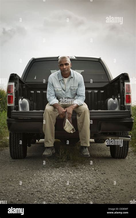 African American Sitting On Back Of Pick Up Truck Stock Photo Alamy
