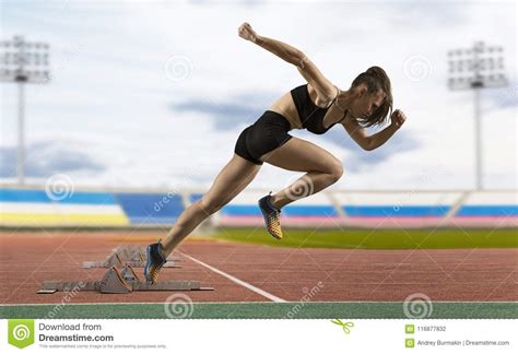 Woman Sprinter Leaving Starting Blocks On The Athletic Track Stock ...