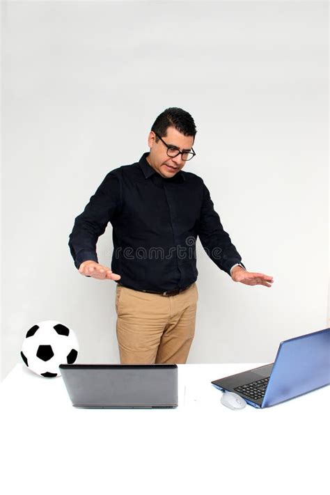 Latino Adult Office Man Watches Football Games On His Work Laptops