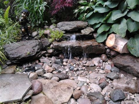 Small landscape waterfall | how to build a pondless waterfall this is the perfect sized waterfall to fit into a front yard. Via christine crookshank | Backyard pondless waterfall ...