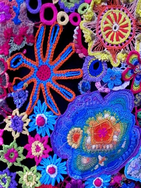 Colorful Crocheted Items Are Displayed On A Black Tablecloth With