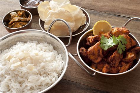 Indian Cuisine With Bread Rice And Spicy Chicken Free Stock Image