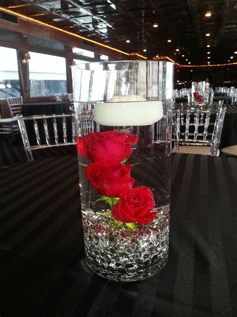 3 Red Roses Submerged With Floating Candle For A Centerpiece Submerged