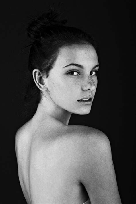 A Black And White Photo Of A Woman With Freckles On Her Body Looking At The Camera
