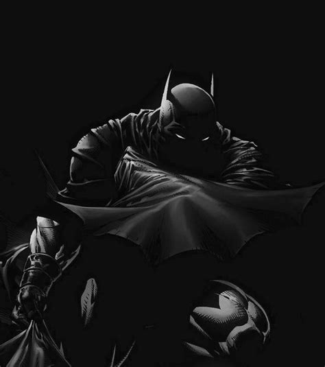 A Black And White Photo Of Batman In The Dark