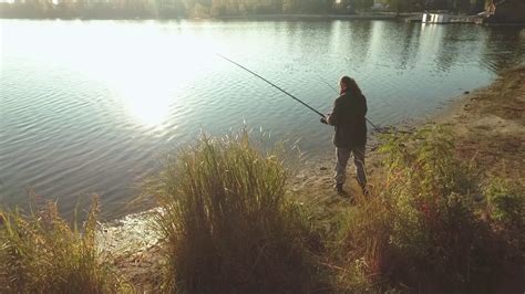 Fisherman Is Fishing On River Bank In Stock Footage Sbv 330000388