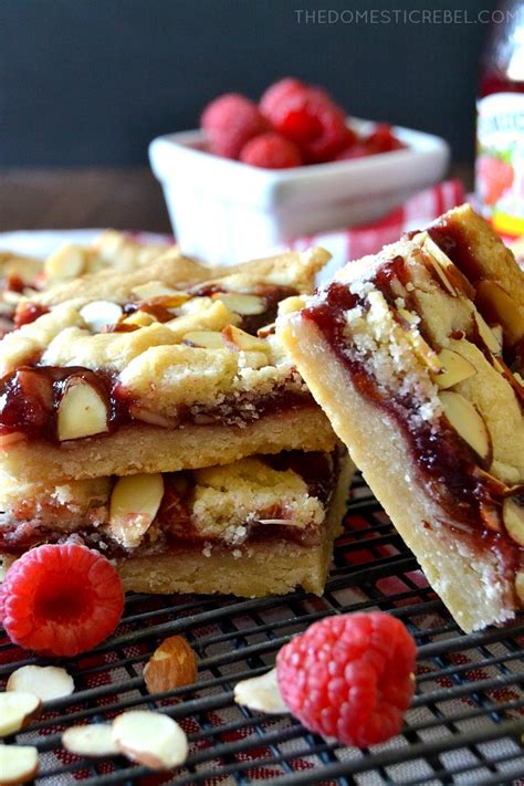 Line an 8x8 square baking pan with parchment, leaving a little hanging over the 2 sides. Raspberry Almond Linzer Shortbread Bars | The Domestic Rebel