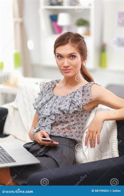 Attractive Businesswoman Sitting On Desk In The Office Stock Image