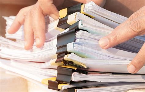 Businessman Hands Searching Unfinished Documents Stacks Of Paper Files