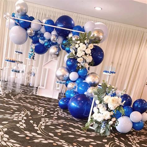 Blue And White Balloons Are Hanging From The Ceiling In An Elegant Room