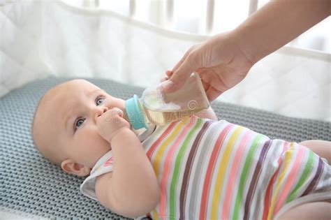 Lovely Mother Giving Her Baby Drink From Bottle Stock Photo Image Of