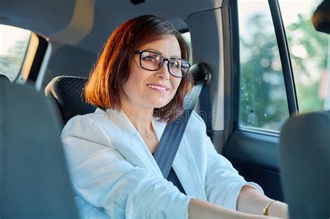 Portrait Of Business Elegant Middle Aged Woman In Car In Back Passenger