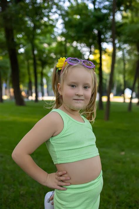 Little Girl Model Posing In The Park In A Green Suit Stock Image