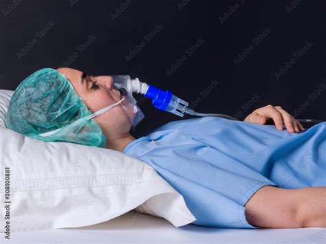 Teenage Girl Lying In A Hospital Bed With Oxygen Mask Stock Photo Adobe Stock